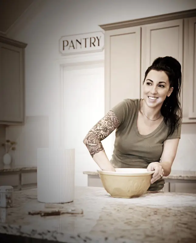Aimee Priedigkeit, owner and baker of Dough, mixing dough in her kitchen