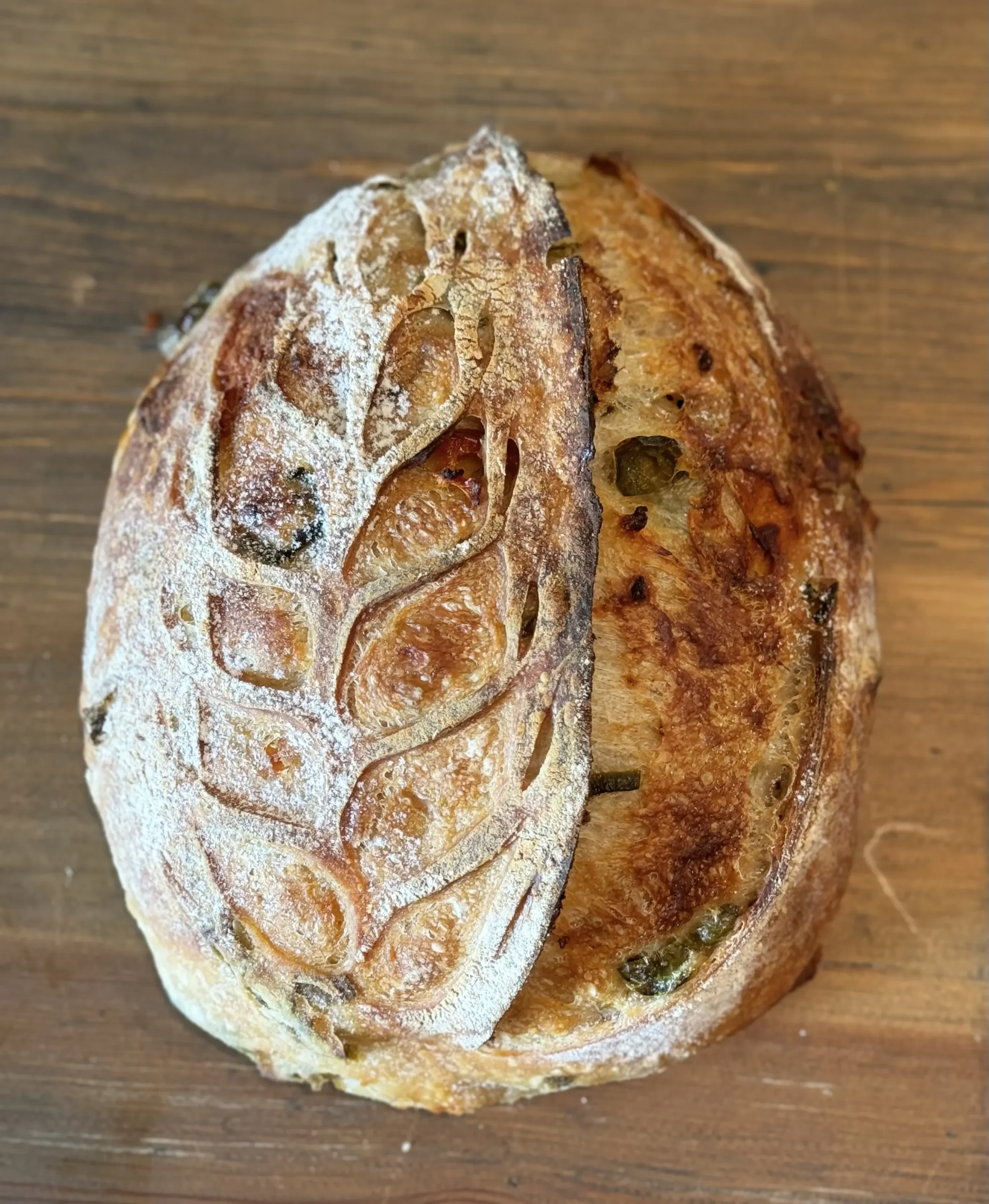 Jalapeño cheddar sourdough loaf studded with melted cheese
