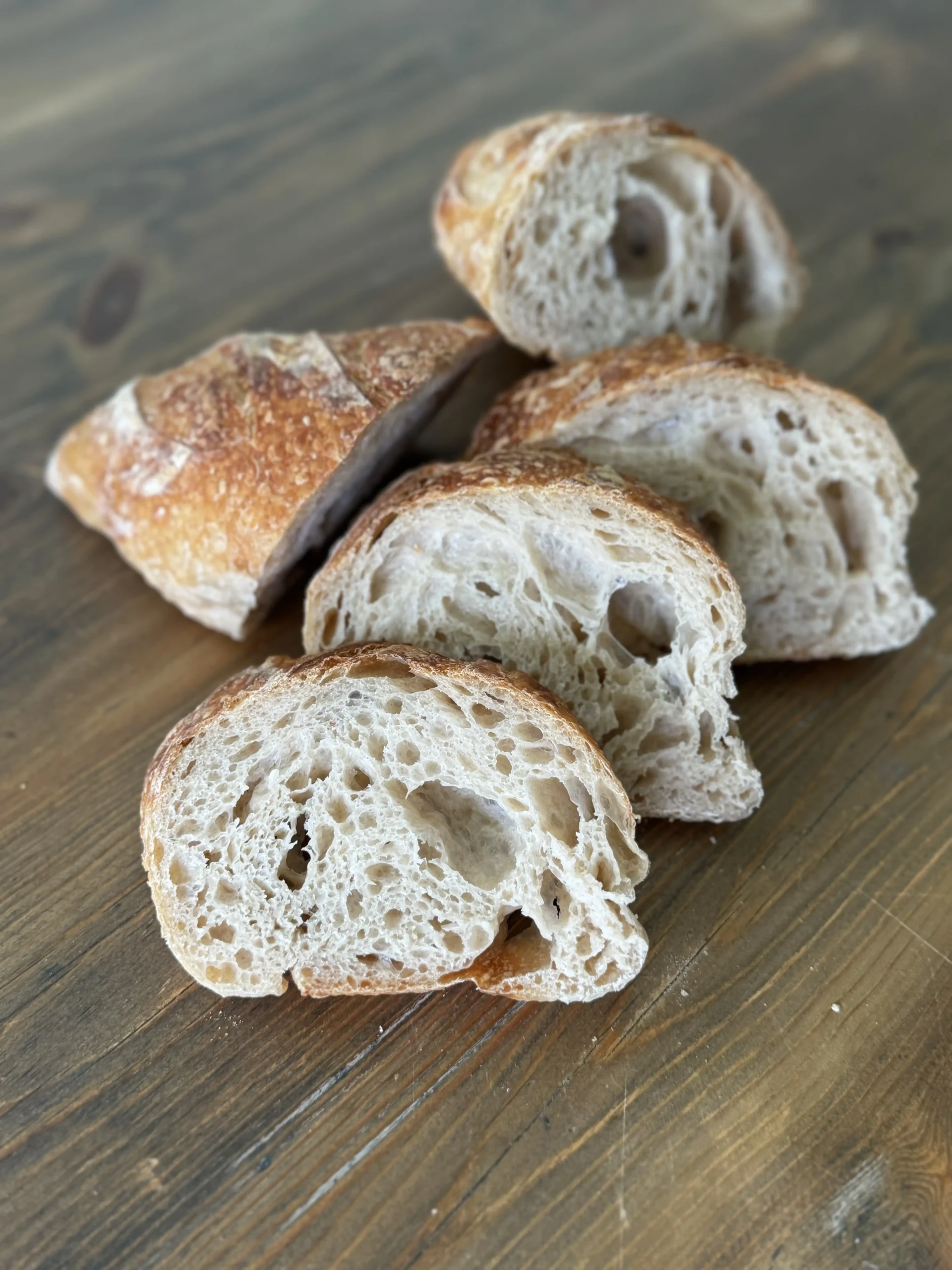 Sliced sourdough loaf showing an open, airy crumb
